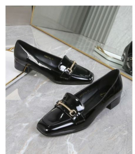 Black patent leather shoes with gold buckles